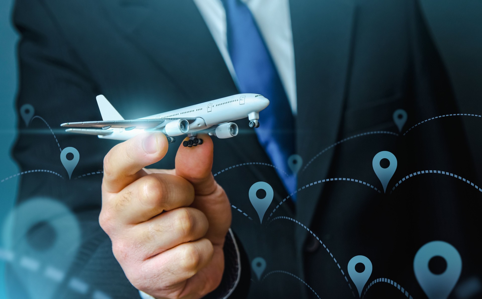 Passenger plane in businessmans hand. Commercial flight management and set new directions. Low cost travel flights. Air traffic communication. Delivery Services. Business trips and tourism. Air miles